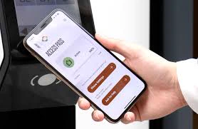 A phone displaying mobile access held beside a physical building reader