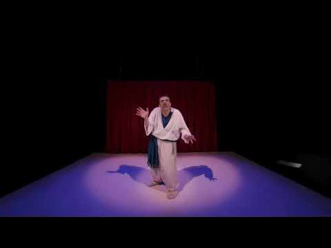 A theatre performer on a lit stage in a supplied BoxOfficeVR performance still