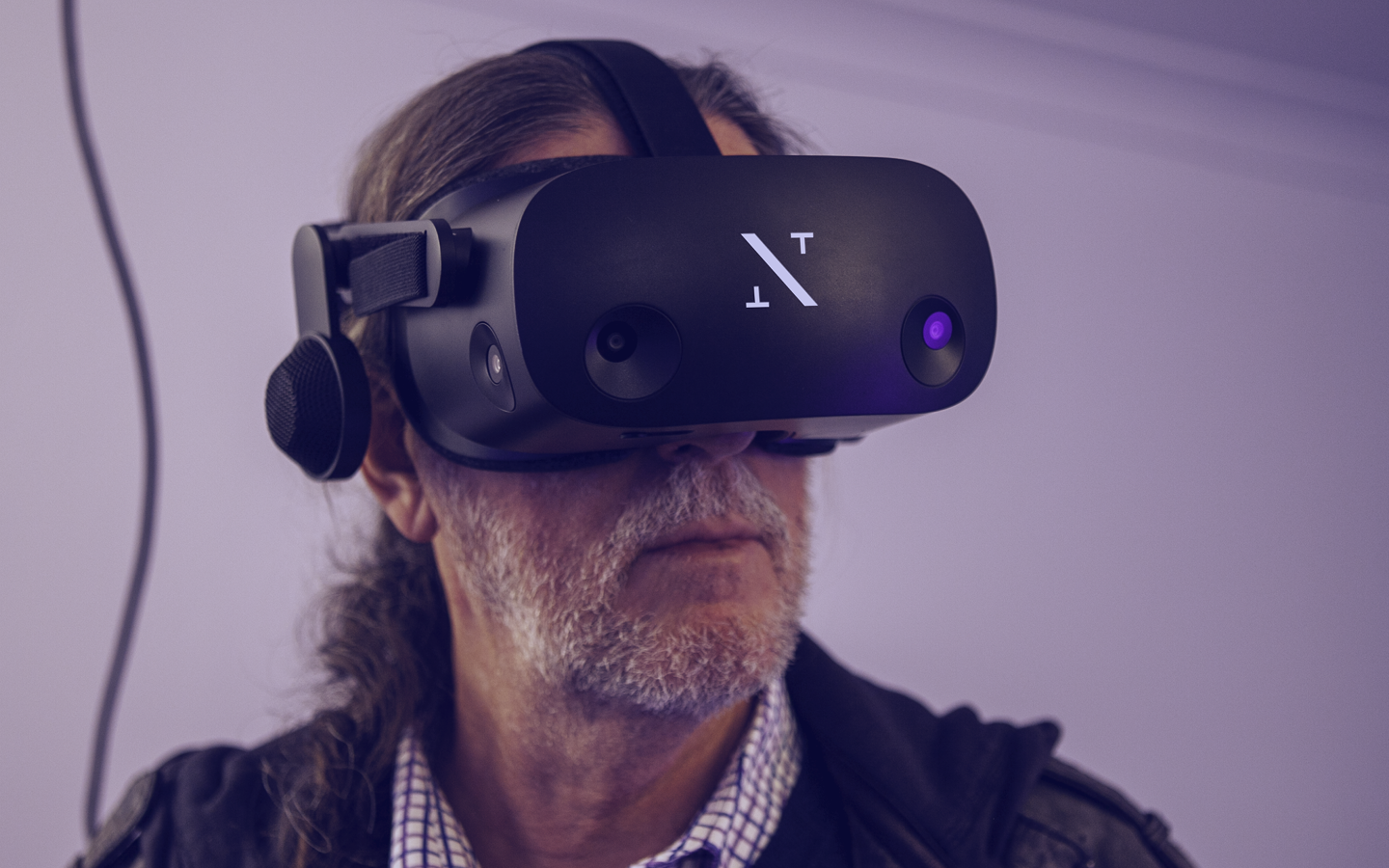 A man wearing a neurotechnology VR headset with integrated sensors